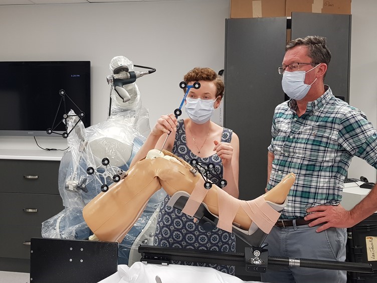 Going to the source of the data: QUT researchers including ACEMS members (not pictured) in the Stryker lab in Brisbane, learning from surgeon Dr Ross Crawford about Stryker’s robotic support for knee replacement surgery, to help understand medical imaging data.